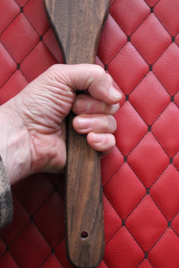 Long Walnut BDSM Gear paddle for impact play. Stingy for bench work
