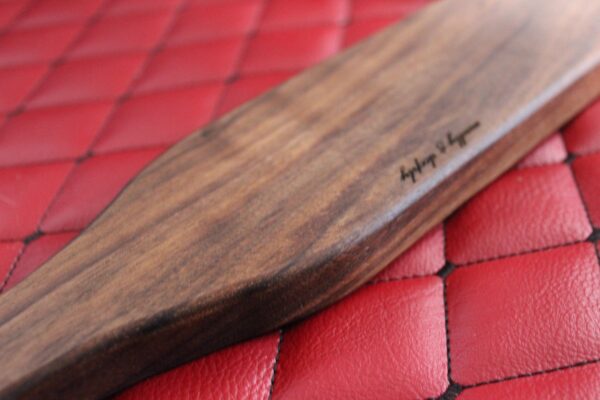 Long Walnut BDSM Gear paddle for impact play. Stingy for bench work
